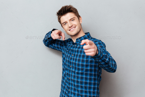 Young man pointing at camera and choosing you