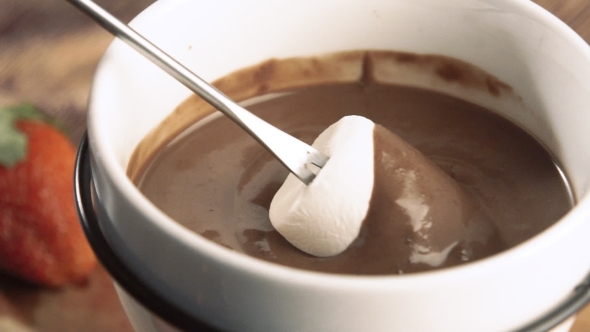 Fondue  Marshmallow Being Dipped in Chocolate