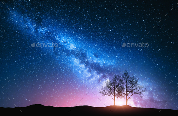 Starry sky with pink Milky Way and trees