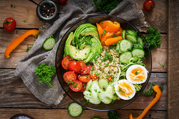 Bulgur porridge, egg and fresh vegetables - tomatoes, cucumber, celery and avocado - Stock Photo - Images