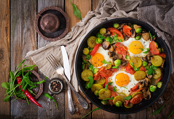 Breakfast for two. Fried eggs with vegetables - shakshuka - Stock Photo - Images