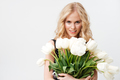 Pretty blonde woman posing with bouquet of flowers - PhotoDune Item for Sale