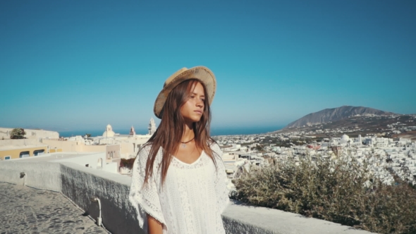 Young Sexy Woman Is on the Greek Island Santorini in a White Dress and and Straw Hat White Greek alt