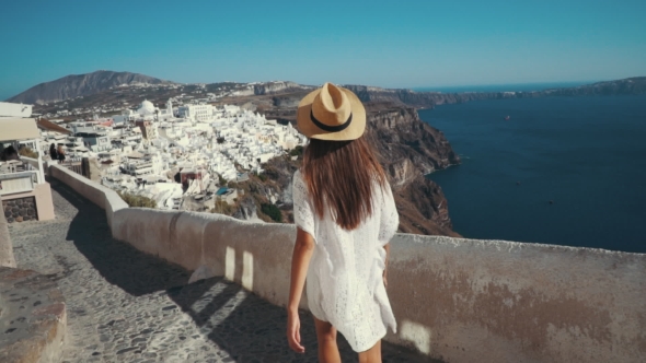 Young Sexy Woman Is on the Greek Island Santorini in a White Dress and and Straw Hat White Greek alt