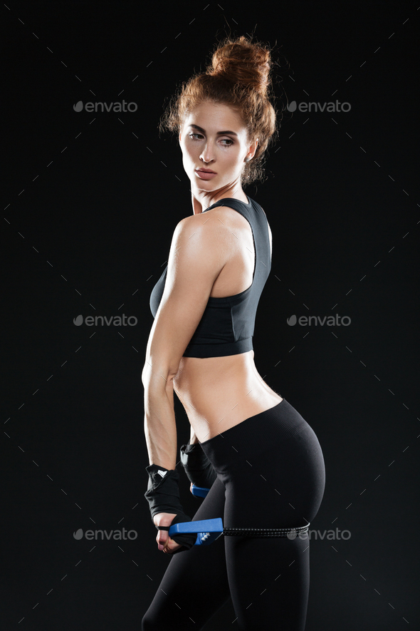 Vertical image of Young Female fighter with expander