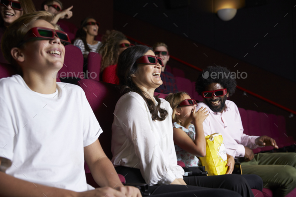 Audience In Cinema Wearing 3D Glasses Watching Comedy Film