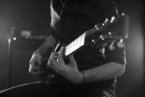 Close Up Of Man Playing Electric Guitar Shot In Monochrome Stock Photo By Monkeybusiness