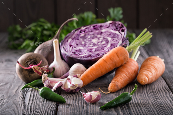 Vegetable still life on wooden table with wooden background - Stock Photo - Images