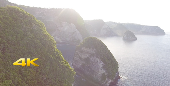 Aerial view of cliff coastline with sunrise