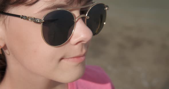 Relaxing Teen in Sunglasses on the Beach alt