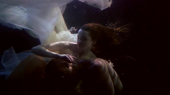 Romantic Loving Pair Is Underwater, Man and Woman Are Embracing, Slow Motion Shot alt