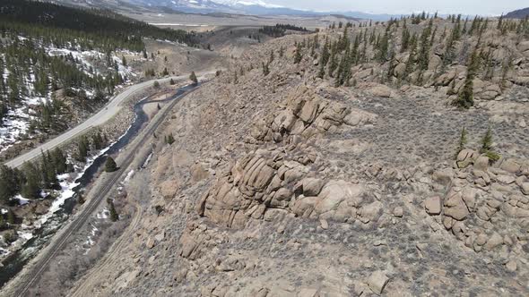 4K drone video of rock formations with Rocky Mountains in background in Colorado. alt