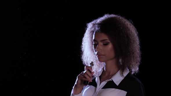 African American Girl Smokes an Electronic Cigarette in an Empty Room ...