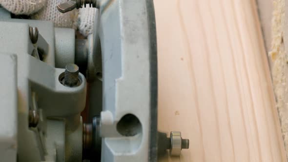 Vertical Shot Joiner Cuts Off the Sharp Corners of a Wooden Beam Using a Milling Machine