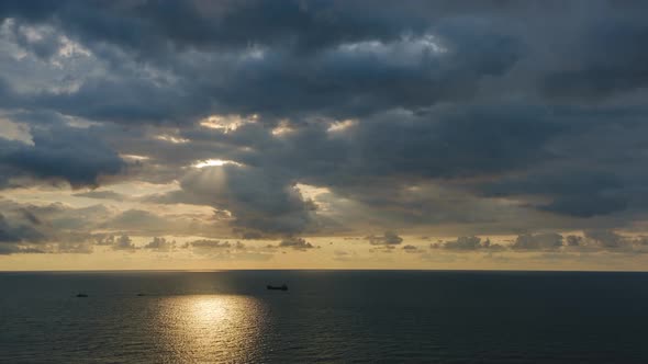 Romantic colorful sunset at the sea. Against the background of the sea the sun goes down alt