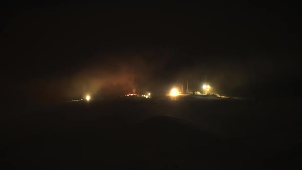 8K Night lights of Antennas on Top of Snowy Mountain in Fog and Clouds