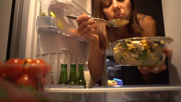 Woman Eating at Night