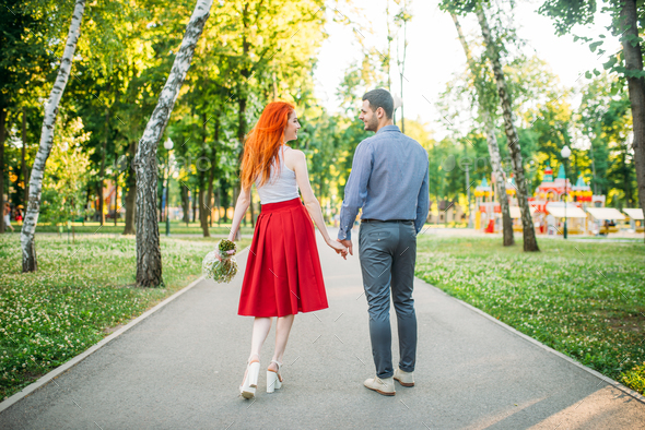 Romantic date, love couple walk in park, back view - Stock Photo - Images