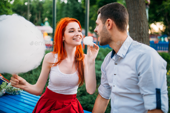 Love couple with cotton candy in summer park - Stock Photo - Images
