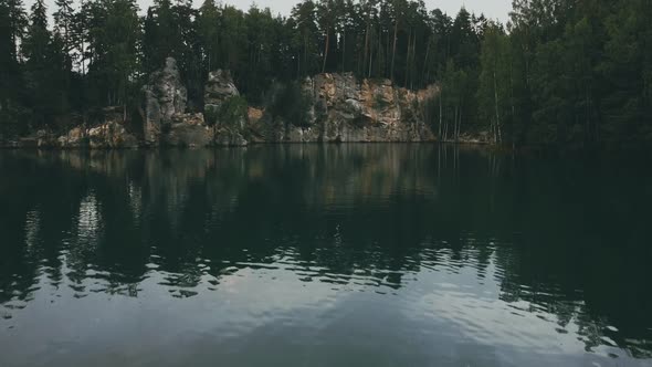 Adršpach-Teplice Rocks national park filmed from drone. Green forest with rocks and blue lake