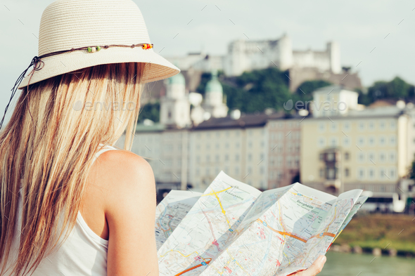 Female tourist on vacation in Salzburg Austria holding a local map