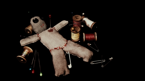 Stitched Voodoo Doll for Ritual on a Black Background with Threads and Needles alt