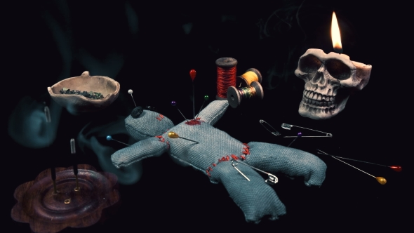 Stitched Voodoo Doll for Ritual on a Black Background with Threads and Needles alt