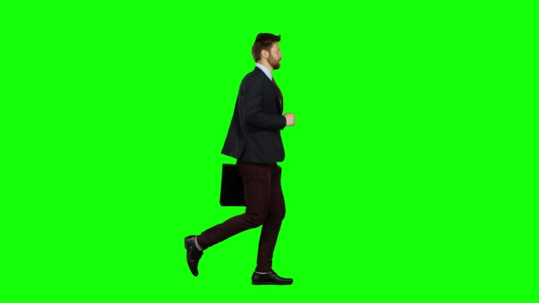 Man Is Running a Briefcase in His Hand, He Rushes Over It. Green Screen alt