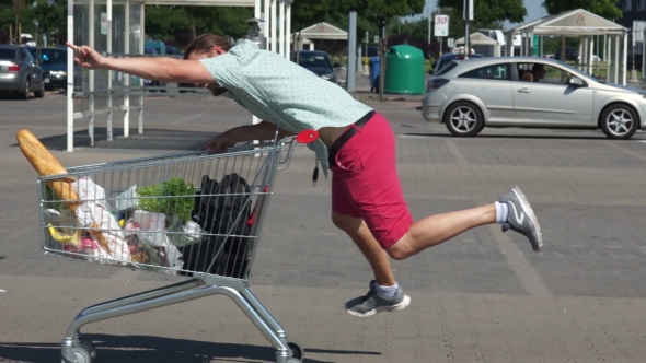 The Guy Is Shopping at the Supermarket. Crazy Shopping