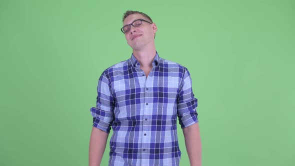 Happy Young Hipster Man Looking Around and Feeling Relaxed alt