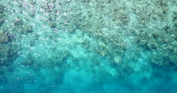 Wide angle aerial island view of a white paradise beach and blue ocean background in best quality 4K alt