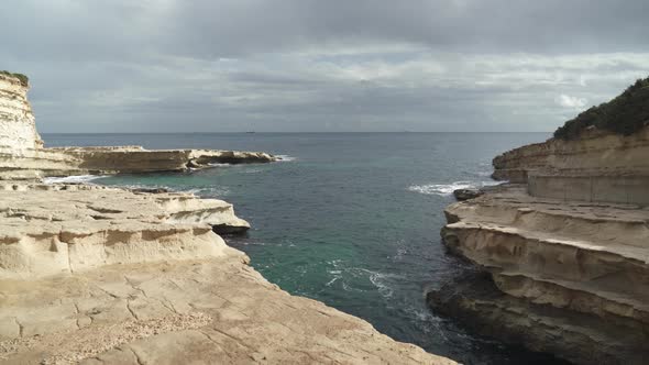 Mediterranean Sea Waves Crashing on Shores of St. Peter's Pool in Malta alt