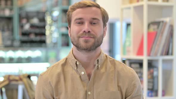 Portrait of Approving Young Man Shaking Head, Yes alt