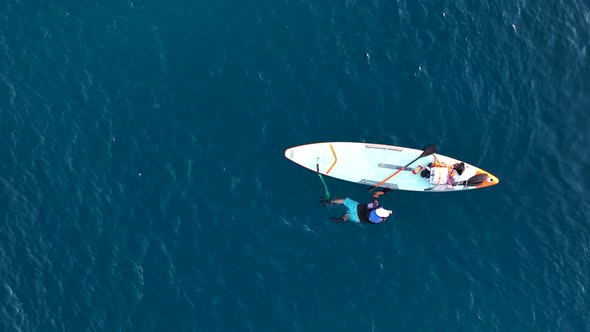 A Man Drifts Surfing the Sea Aerial View 4 K alt