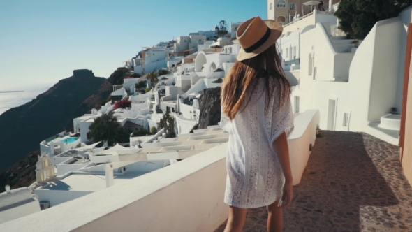 Young Sexy Woman Is on the Greek Island Santorini in a White Dress and and Straw Hat White Greek alt