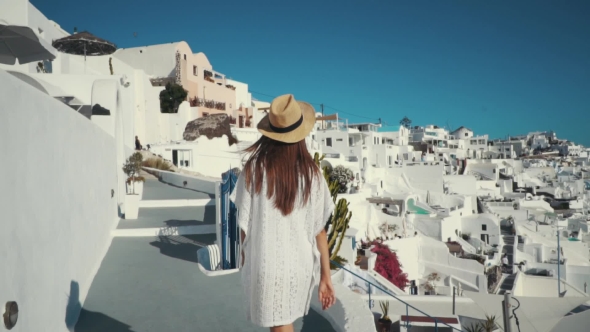 Young Sexy Woman Is on the Greek Island Santorini in a White Dress and and Straw Hat White Greek alt