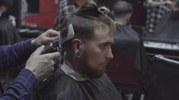 Barber Cuts the Hair of the Client with Trimmer in Barbershop alt