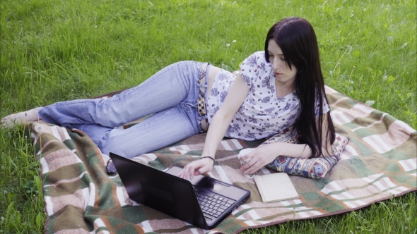Woman Using Laptop in Park