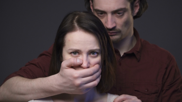 Domestic Violence, Man Closing Woman’s Mouth by the Hand