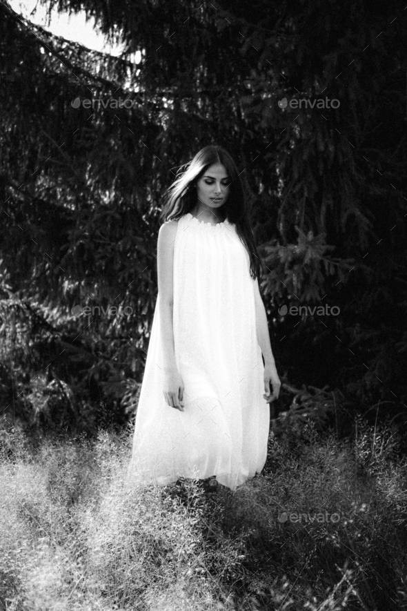 Ghost covered with a white ghost sheet on a rural path. Grainy textured ...