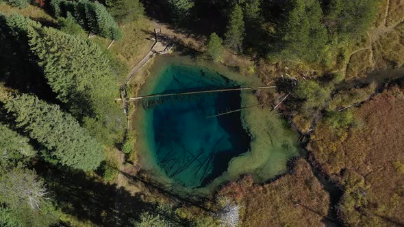 Aerial top down spinning shot of Little Crater lake in Oregon. alt