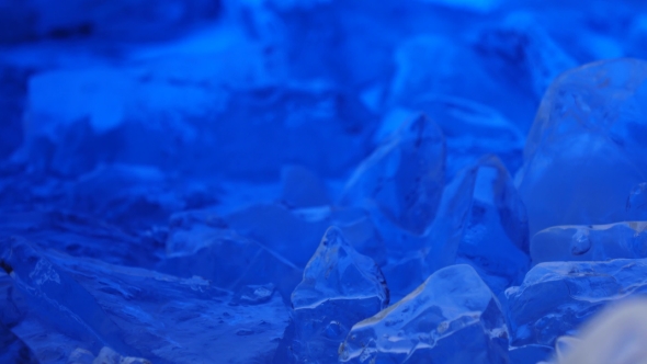 Pieces of Ice Lies on the Table, Blue Illumination Beautifully Lies Over Fragments. alt