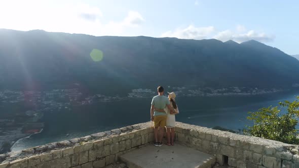 Aerial View of a Couple Standing on the Edge of the Old Fortress of Kotor