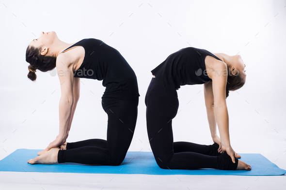 Young woman in yoga class, tree pose asana Stock Photo by ©Milkos 168654994