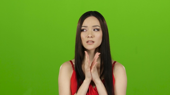 Girl Is Asian, Hoping for a Win and Crossing Her Fingers. Green Screen alt