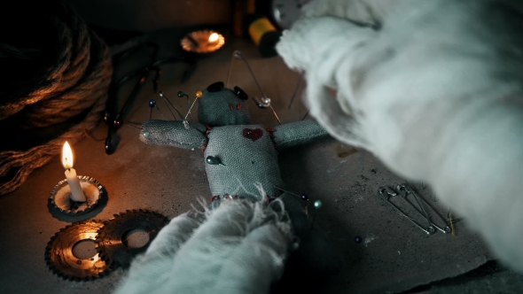 the Mage Conducts a Ritual with a Voodoo Doll and Sticks Pins in It alt