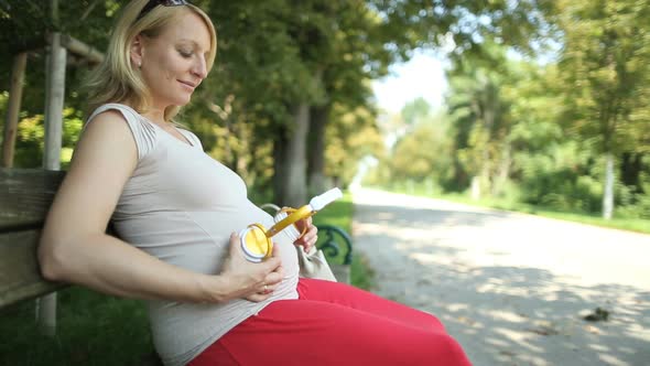 Pregnant Woman With Headphones on Belly