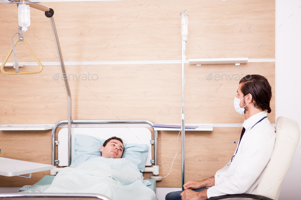 Doctor with patient in recovery room