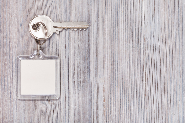 key with key chain on wooden background - Stock Photo - Images