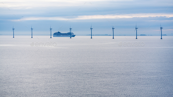 ferry near offshore wind farm in morning twilight - Stock Photo - Images
